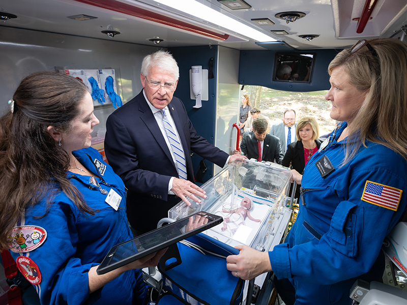 U.S. Sen. Roger Wicker learns about a specialized intensive care isolette from  transport nurse practitioner Casey Hall, left, and transport registered nurse April Davidson. The Mississippi Center for Emergency Services' deployable vehicles includes critical care transport for newborns.